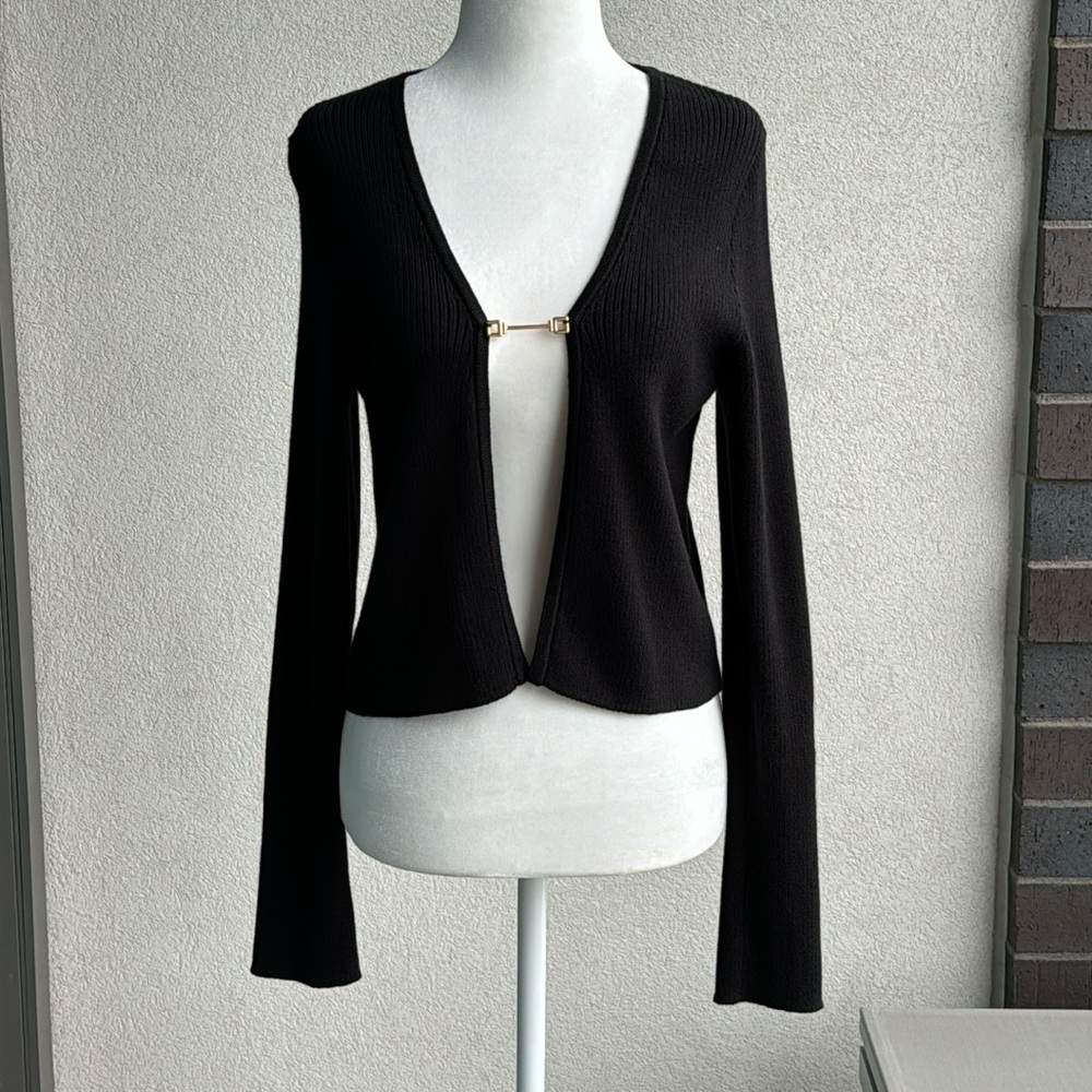 Black open crop top/cardi. ribbed material. gold plate charm at bust. Size S